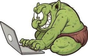 Illustration of green troll using laptop.
