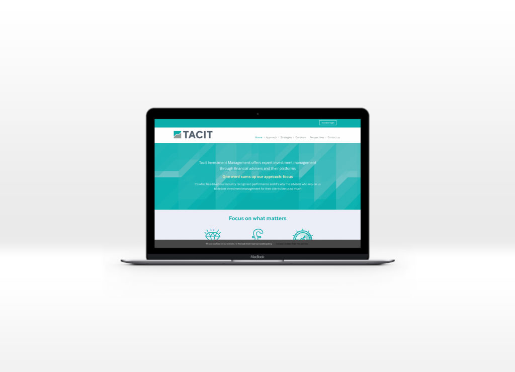 Tacit homepage displayed on a Mac laptop computer