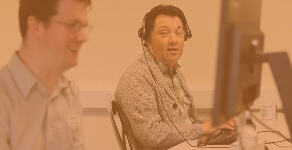 Alan from Shaw Trust conducting an accessibility testing on a computer, wearing a headset