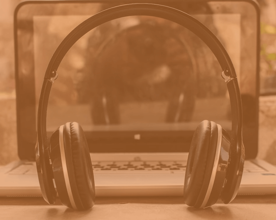 a headset standing up in front of a laptop