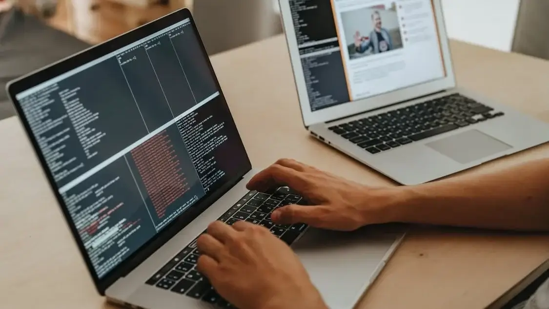 someone assessing a website's coding on a laptop