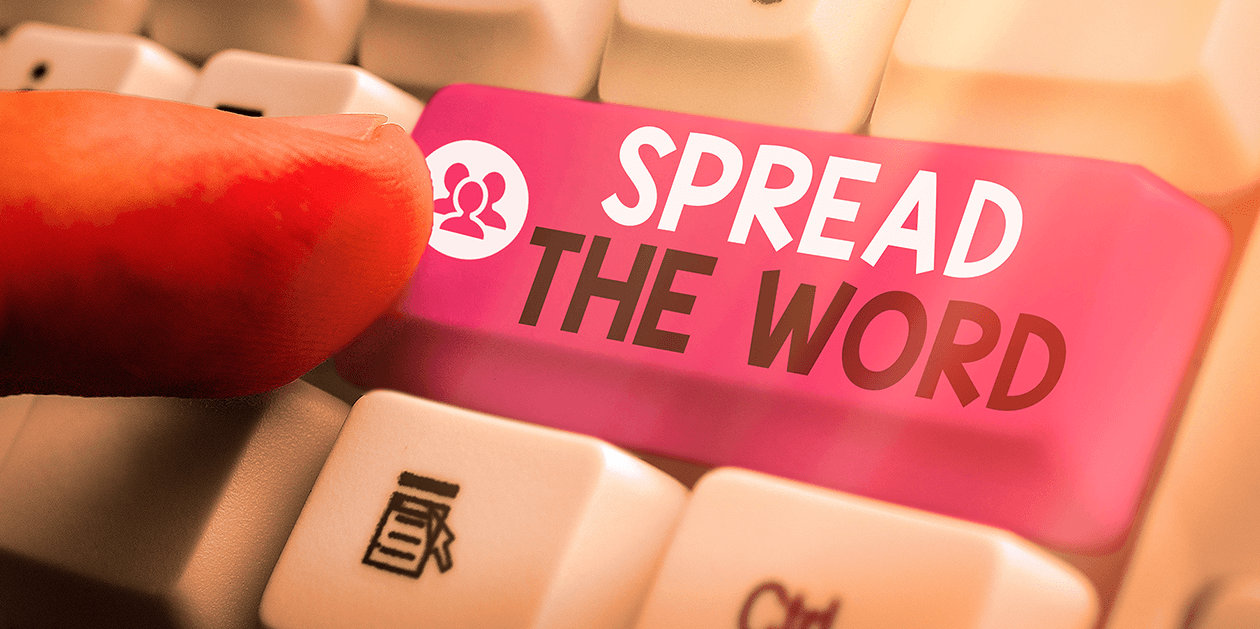 a key on a keyboard which says "spread the word" next to an icon of a group of people