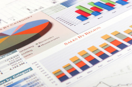 a piece of paper which has an array of pie charts and bar charts across it, showing how someone without colour blindness would view the vibrant colours.