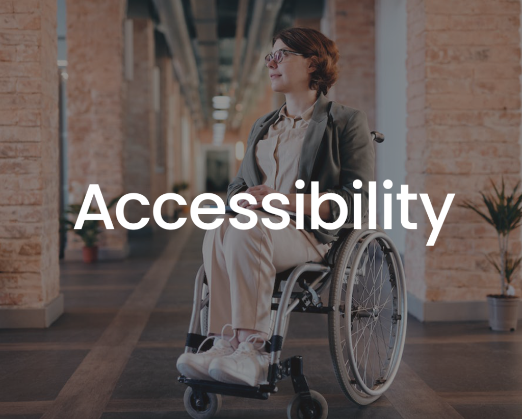 a wheelchair user in an office environment, which has the word "accessibility" in white letters, but this time the picture has a dark grey overlay making the text easier to read