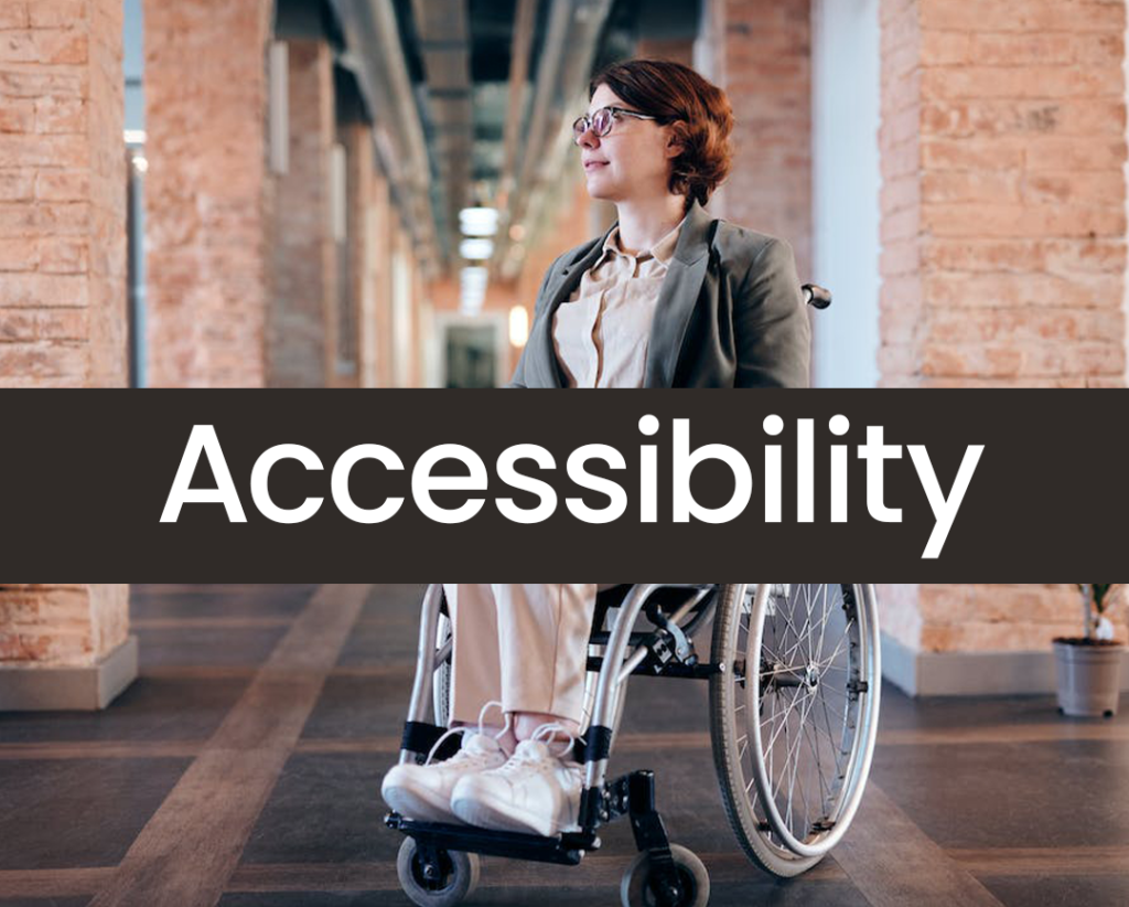a wheelchair user in an office environment, which has the word "accessibility" in white letters with a solid black box behind it, making the text easy to read.