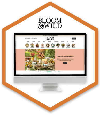 A desktop monitor is displaying Bloom & Wild's homepage